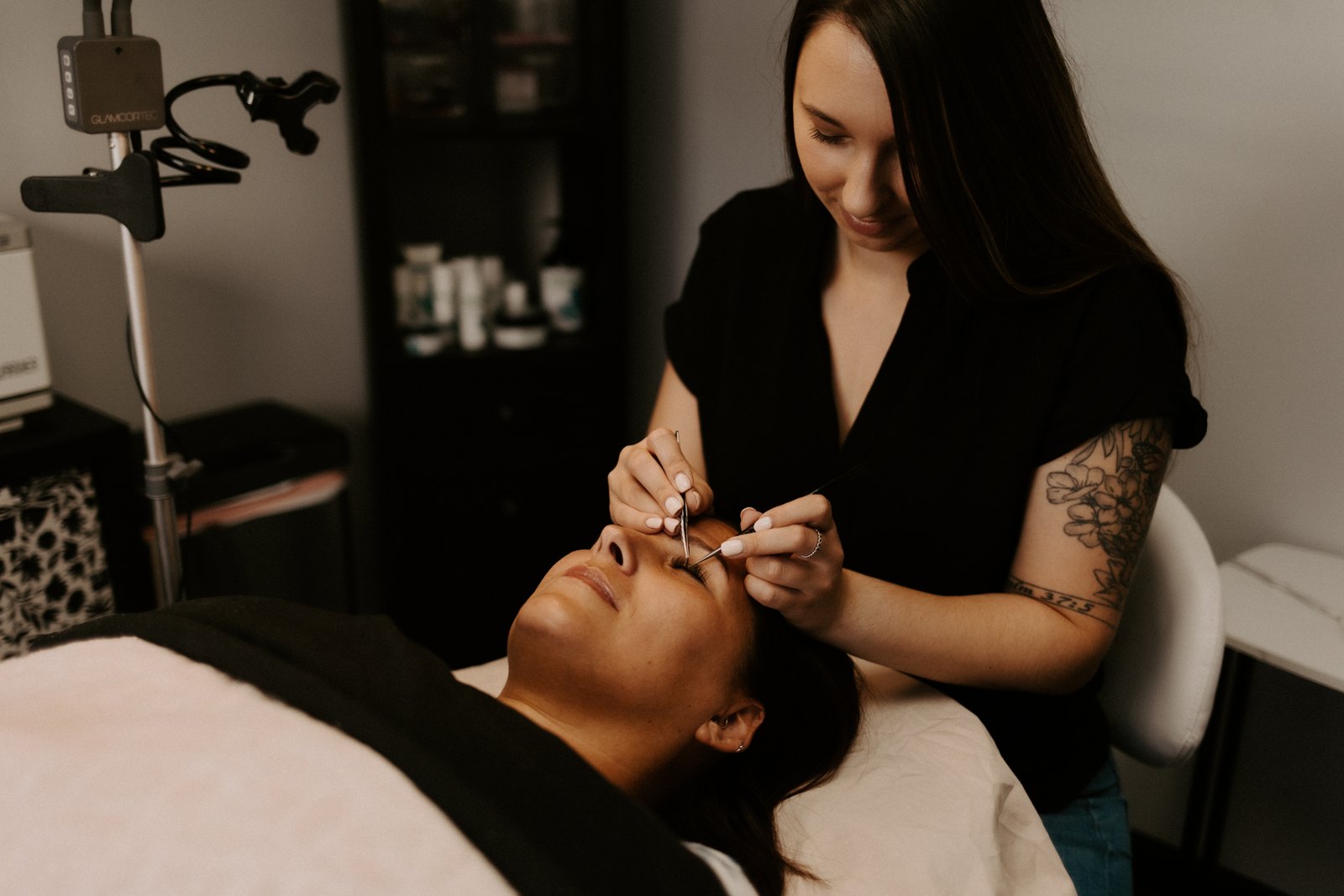 Bryanna applying lash extensions in her studio